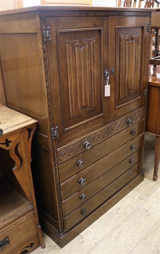 A linenfold carved cupboard / chest and a matching pair of bedside tables (3)